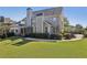 Spacious backyard showcasing the home's exterior, patio, and a well-maintained lawn at 403 Grassmeade Way, Snellville, GA 30078