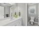 Modern bathroom featuring double sink, mirror, shower, and neutral walls at 403 Grassmeade Way, Snellville, GA 30078
