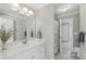 Neutral-colored bathroom featuring a vanity, large mirror, and a shower/tub combo with a decorative curtain at 403 Grassmeade Way, Snellville, GA 30078