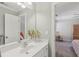 Bathroom with white vanity, large mirror, and access to the bedroom at 403 Grassmeade Way, Snellville, GA 30078