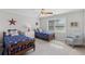 Bright bedroom with two beds, patriotic decor, and a window that provides natural light at 403 Grassmeade Way, Snellville, GA 30078