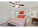 Bedroom featuring bright walls, ceiling fan, bed, and access to bathroom at 403 Grassmeade Way, Snellville, GA 30078