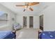 Neutral colored bedroom with two beds, a fan, and a chair at 403 Grassmeade Way, Snellville, GA 30078