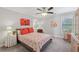 Bedroom featuring bright walls, bed, ceiling fan, and hardwood cabinet at 403 Grassmeade Way, Snellville, GA 30078