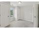 Spare bedroom with carpet flooring, two windows, and crisp white walls at 403 Grassmeade Way, Snellville, GA 30078