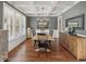 Elegant dining room with coffered ceiling, hardwood floors, and ample natural light for enjoyable meals at 403 Grassmeade Way, Snellville, GA 30078