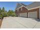 Home exterior featuring a paved driveway, a basketball hoop, and a large garage at 403 Grassmeade Way, Snellville, GA 30078