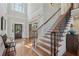 Grand foyer with hardwood floors, a staircase, high ceilings, and a view into the dining area at 403 Grassmeade Way, Snellville, GA 30078