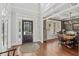 Elegant foyer featuring hardwood floors, a stylish front door, and an adjacent dining area with coffered ceilings at 403 Grassmeade Way, Snellville, GA 30078