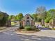 Beautiful entrance to a well-maintained community with meticulous landscaping and secure access at 403 Grassmeade Way, Snellville, GA 30078