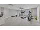 Spacious home gym with a treadmill, elliptical machine, multi-station weight machine, and ample space for activities at 403 Grassmeade Way, Snellville, GA 30078