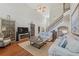 Open concept living room with hardwood floors, a staircase, a fireplace, and stylish decor at 403 Grassmeade Way, Snellville, GA 30078