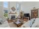 Bright living room featuring a fireplace, large windows, hardwood floors, and comfortable seating at 403 Grassmeade Way, Snellville, GA 30078