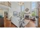 Spacious living room with high ceilings, fireplace, hardwood floors, and large windows providing ample natural light at 403 Grassmeade Way, Snellville, GA 30078