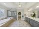 Luxurious main bathroom with dual vanity, soaking tub and glass-enclosed shower at 403 Grassmeade Way, Snellville, GA 30078