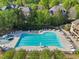 A large in-ground pool with lounge chairs and umbrellas provides residents with recreational options at 403 Grassmeade Way, Snellville, GA 30078