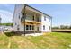 A two-story house featuring a covered deck, a concrete patio and expansive yard at 4202 Adler Cir, Buford, GA 30519