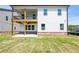 A two-story home with a covered deck and a brick foundation, complemented by a well-maintained lawn at 4202 Adler Cir, Buford, GA 30519