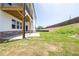 Backyard featuring the house, covered patio, grass area, and retaining wall at 4202 Adler Cir, Buford, GA 30519
