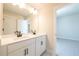 Well-lit bathroom with a double sink vanity, white cabinets, and modern fixtures at 4202 Adler Cir, Buford, GA 30519