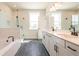 Bathroom features double sinks, white cabinets, black fixtures, tub, and tile floors at 4202 Adler Cir, Buford, GA 30519