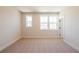 Bright bedroom with neutral walls, plush carpet, and two windows providing ample natural light at 4202 Adler Cir, Buford, GA 30519