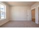 This bedroom features carpeted floors, neutral walls, white trim, and a large window at 4202 Adler Cir, Buford, GA 30519