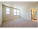 Spacious bedroom featuring carpet floors, white trim, and bathroom access at 4202 Adler Cir, Buford, GA 30519