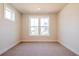 Bright bedroom with neutral carpet, base trim, and large double hung windows at 4202 Adler Cir, Buford, GA 30519