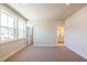 Spacious bedroom featuring neutral carpet and walls, along with a view to an ensuite bathroom at 4202 Adler Cir, Buford, GA 30519