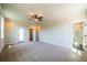 Bonus room with carpeted floors, neutral walls, white trim, ceiling fan and exterior door at 4202 Adler Cir, Buford, GA 30519
