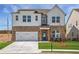 Beautiful two-story home featuring a brick and white siding exterior with a well-manicured front yard and an attached garage at 4202 Adler Cir, Buford, GA 30519