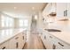 Bright kitchen with island, white cabinets and drawers, and stainless steel appliances at 4202 Adler Cir, Buford, GA 30519
