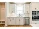 Kitchen with white cabinets, stainless dishwasher, and a window above the sink at 4202 Adler Cir, Buford, GA 30519