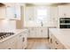 Modern kitchen featuring white cabinets, subway tile backsplash, and stainless steel appliances at 4202 Adler Cir, Buford, GA 30519