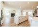 Open kitchen design with white cabinets, kitchen island, and stainless steel appliances at 4202 Adler Cir, Buford, GA 30519