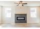 Cozy living room featuring a modern fireplace, natural light from the windows, and stylish flooring at 4202 Adler Cir, Buford, GA 30519
