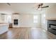 Open-concept living space with a modern fireplace, kitchen island, and sleek appliances at 4202 Adler Cir, Buford, GA 30519