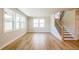 Bright and airy living area with large windows, staircase, and stylish flooring at 4202 Adler Cir, Buford, GA 30519