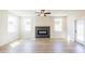 Cozy living room featuring a modern fireplace, natural light from the windows, and stylish flooring at 4202 Adler Cir, Buford, GA 30519