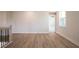 Living room with wood floors, neutral walls and white trim. Stair railing on the left at 4202 Adler Cir, Buford, GA 30519