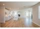 Bright open concept living space with kitchen featuring white cabinets, island, and fireplace at 4202 Adler Cir, Buford, GA 30519