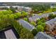 An aerial view showcases a neighborhood with lush trees and modern townhomes, creating a serene residential setting at 11302 Musette Cir, Alpharetta, GA 30009