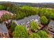 Aerial view of a townhome community with lush greenery, gray roofs, and brick accents at 11302 Musette Cir, Alpharetta, GA 30009
