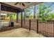 Backyard featuring a concrete patio with a black metal fence and trees at 11302 Musette Cir, Alpharetta, GA 30009