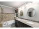 Luxurious bathroom features a double sink vanity, soaking tub, and elegant lighting fixtures at 11302 Musette Cir, Alpharetta, GA 30009