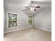 A spacious bedroom with large windows and a ceiling fan offers ample natural light at 11302 Musette Cir, Alpharetta, GA 30009