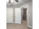 Spacious bedroom with neutral carpet, two closets, and doorways to other rooms at 11302 Musette Cir, Alpharetta, GA 30009