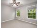 Bedroom featuring two windows, neutral paint, and carpet at 11302 Musette Cir, Alpharetta, GA 30009
