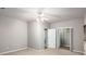Spacious bedroom with ceiling fan, neutral walls and carpet, and two closet doors at 11302 Musette Cir, Alpharetta, GA 30009